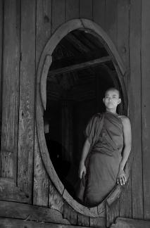 Burma novice monk in window