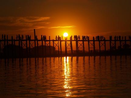 SUNSET ON A BRIDGE IN BURMA