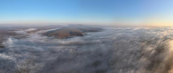 Clouds fill the autumn mountains