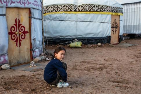 GIRL IN FRONT OF YURTS