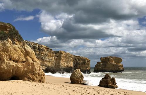 Beach rocks under clouds